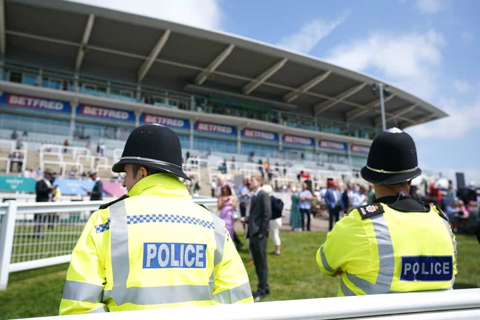 Two police officers look on at Epsom (Tim Goode/PA)