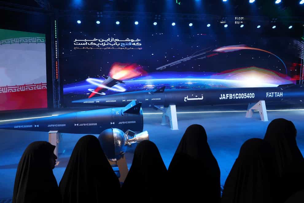 Women look at the Fattah missile at a ceremony in Tehran, Iran (Hossein Zohrevand/Tasnim News Agency/AP)