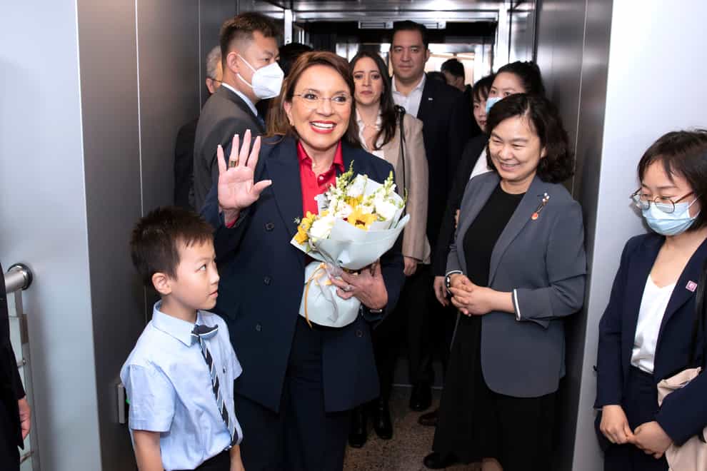 Honduras’ president Xiomara Castro waves as she arrives in Shanghai (Gao Feng/Xinhua via AP)