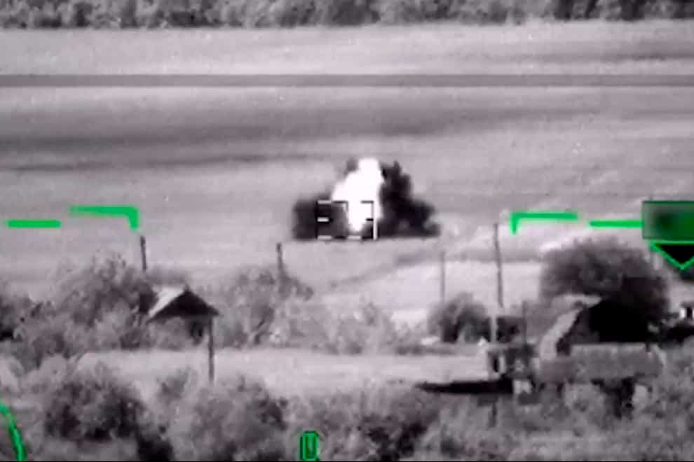 In this image from video, released by the Russian Defense Ministry Press Service on June 6, 2023, shows what Russia claimed was the destruction of a German-made Leopard tank. But a visual analysis by The Associated Press shows the grainy black-and-white video Russia released prove it had blown up the tanks actually documented the destruction of a tractor. Two experts, who watched the Russian video, both said the vehicle struck by the helicopter’s missile was not a Leopard tank, or any other type of armored vehicle. Valentin Châtelet, a research associate at The Atlantic Council’s Digital Forensic Research Lab, also said the objects in the video were clearly not Leopard tanks.(Russian Defense Ministry Press Service via AP)