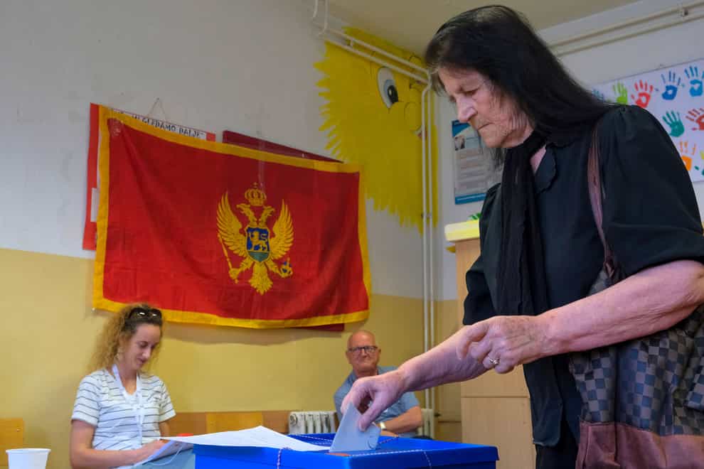 A woman casts her ballot at a polling station in Montenegro’s capital Podgorica (Risto Bozovic/AP)