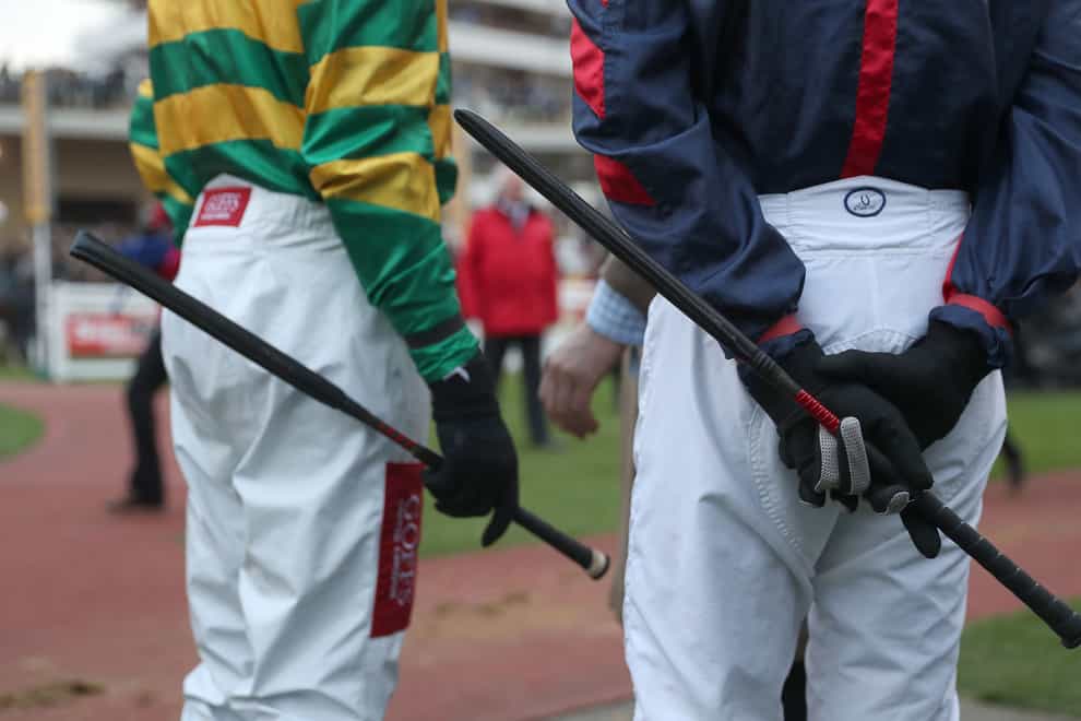 Jockeys with their whips. (David Davies/PA)
