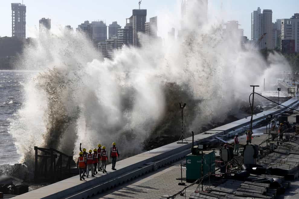 Officials in Mumbai are making arrangements to tackle the approach of Cyclone Biparjoy. (AP Photo/Rajanish Kakade)