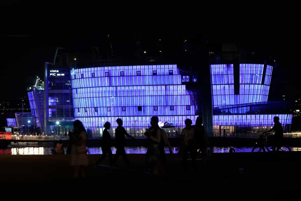 The landmark building on Sebitseom Island is illuminated in purple on the Han River in Seoul (Ahn Young-joon/AP)