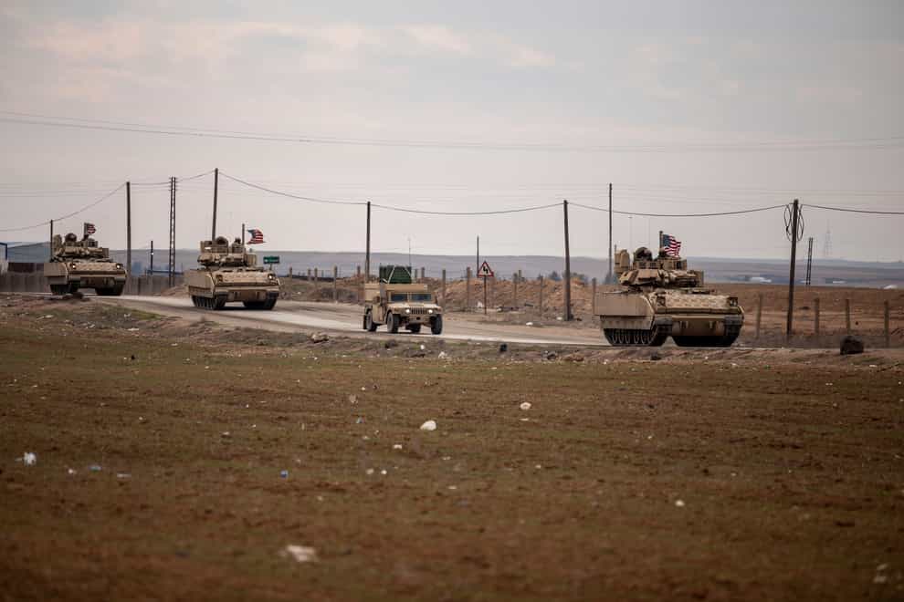 An American military convoy travels on a road in Hassakeh, Syria (Baderkhan Ahmad/AP)