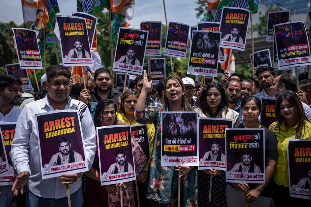 Supporters of opposition Congress party hold placards during a protest rally against the wrestling federation chief Brij Bhushan Sharan Singh over allegations of sexual harassment (Altaf Qadri/AP/PA)