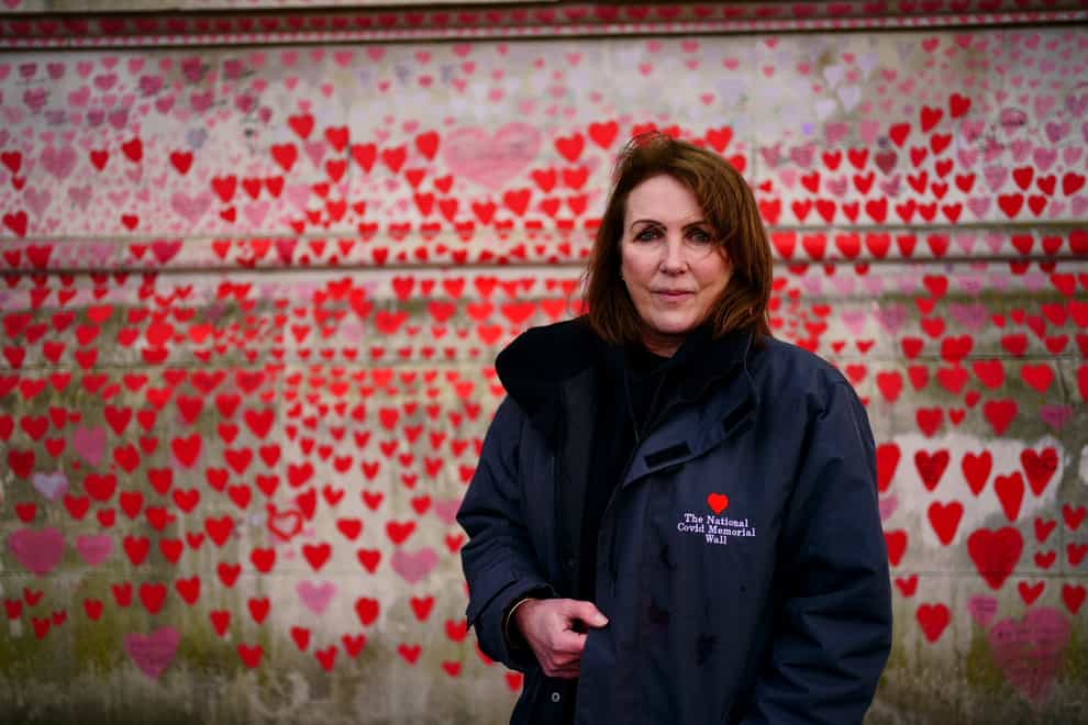 Fran Hall, whose husband served in the police for more than three decades before dying with coronavirus, and who is spokesperson for the Covid-19 Bereaved Families For Justice campaign group, standing by the National Covid Memorial Wall opposite the Palace of Westminster (Victoria Jones/PA)