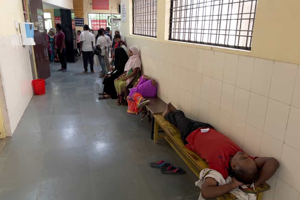 People wait to consult doctors at Tej Bahadur Sapru Hospital in Prayagraj, Uttar Pradesh (AP)