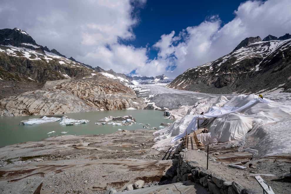 Chunks of ice float in a lake in front of the Rhone Glacier (Matthias Schrader/AP)