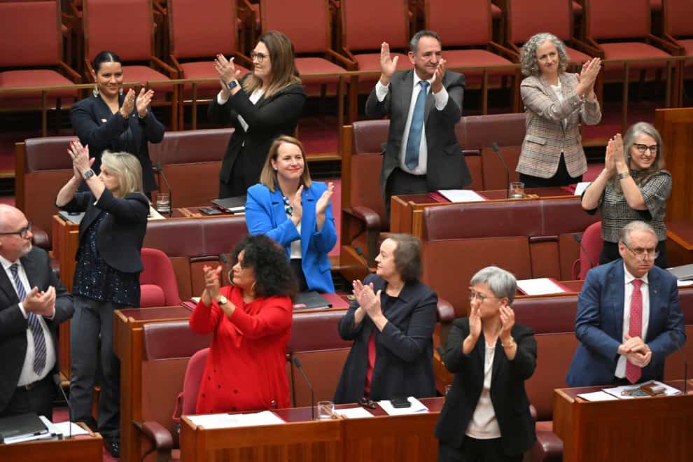 Labor senators applaud after the passing of the Voice to Parliament in the Senate chamber at Australia’s Parliament House in Canberra (Mick Tsikas/AAP/AP)