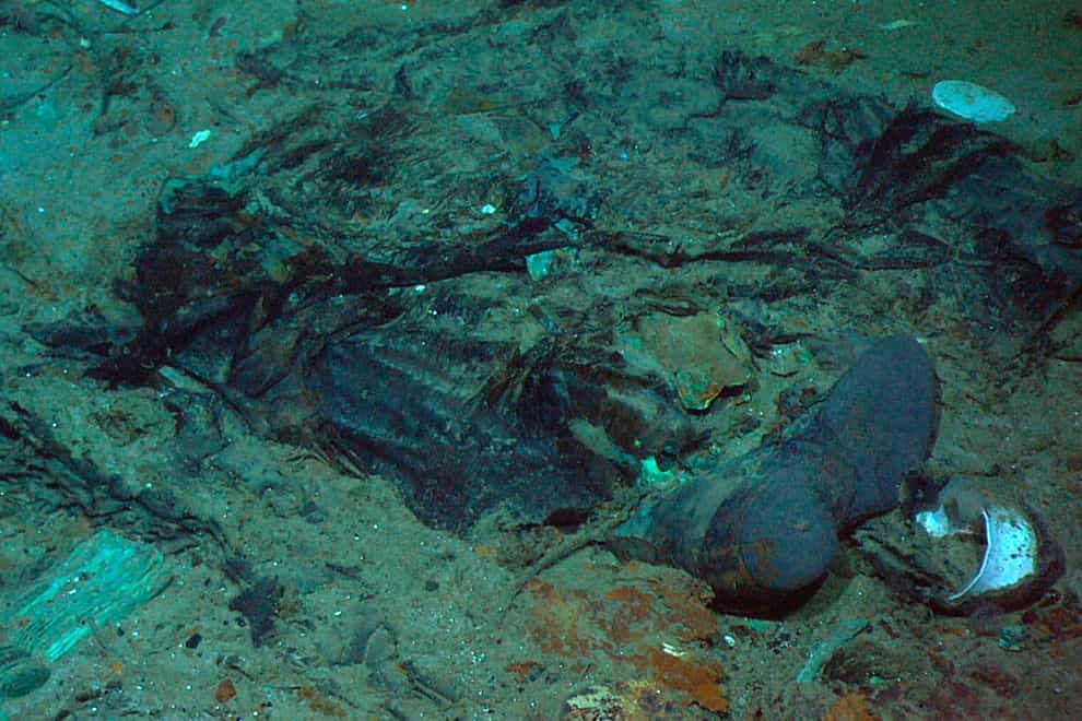 FILE – This 2004 photo provided by the Institute for Exploration, Center for Archaeological Oceanography/University of Rhode Island/NOAA Office of Ocean Exploration, shows the remains of a coat and boots in the mud on the sea bed near the Titanic’s stern. A search is underway for a missing submersible that carries people to view the wreckage of the Titanic, according to media reports. The U.S. Coast Guard told BBC News that a search was underway Monday, June 19, 2023, off the coast of Newfoundland. (Institute for Exploration, Center for Archaeological Oceanography/University of Rhode Island/NOAA Office of Ocean Exploration, File)