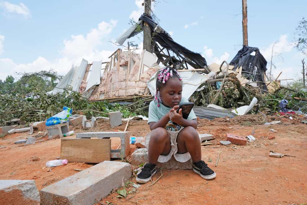 Genesis Jackson, three, sits in front of a relative’s home following an apparent Sunday night tornado that swept through the small community of Louin, Miss., Monday, June 19, 2023. Possible multiple tornadoes swept through Mississippi overnight, killing one and injuring nearly two dozen, officials said Monday. (AP Photo/Rogelio V. Solis)