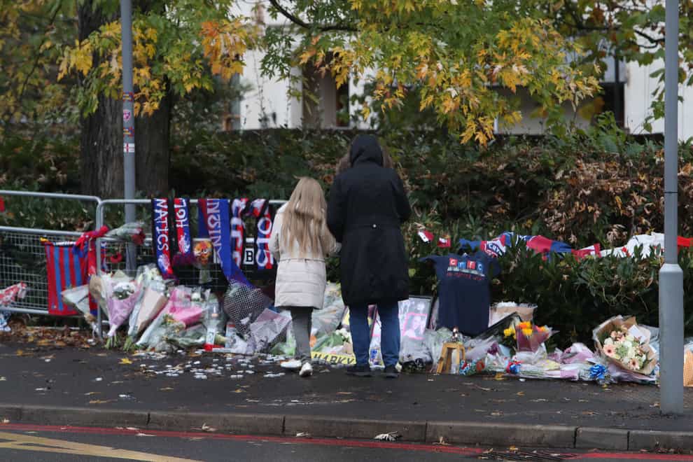 Tributes left near the scene where Tram 2551 crashed, killing seven people, in Croydon, south London (Steve Parsons/PA)