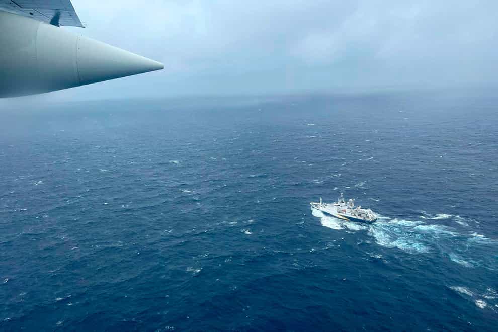 A Coast Guard Hercules airplane flies over the French research vessel, L’Atalante during the search ((US Coast Guard via AP)
