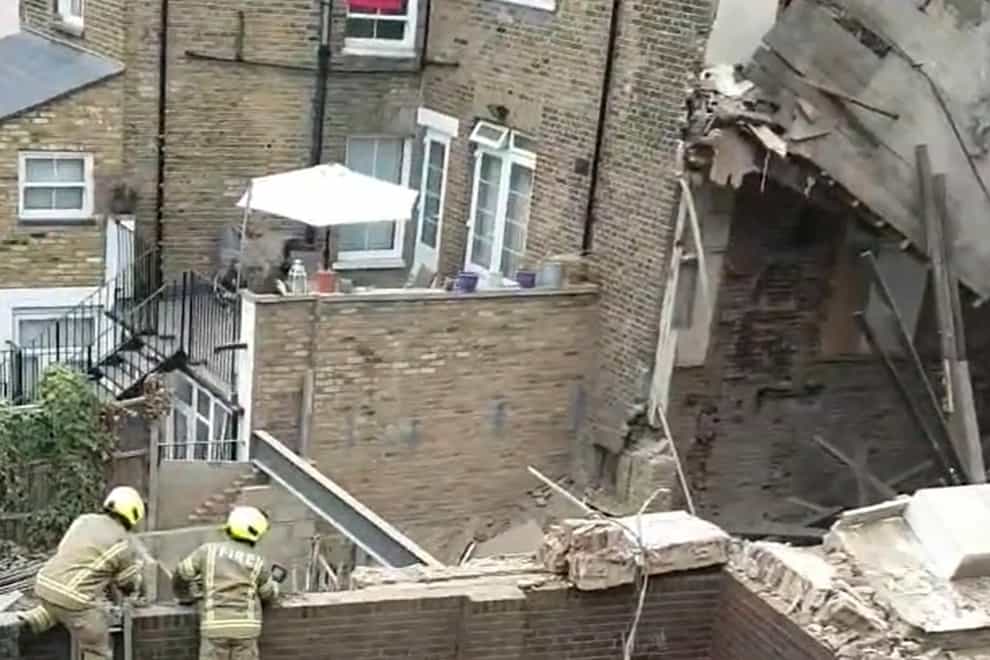 The scene of a building collapse in Hackney, London (@QueenA12282970/Twitter)
