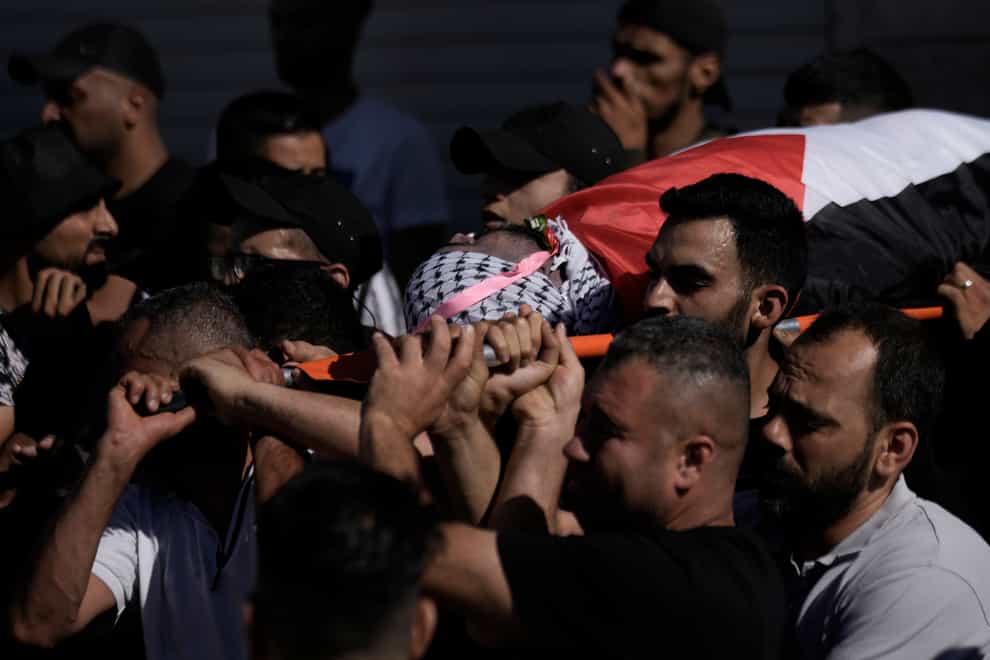 Palestinian mourners carry the body of Tariq Idris, 39, during his funeral, in Askar refugee camp near the West Bank city of Nablus (Majdi Mohammed/AP)