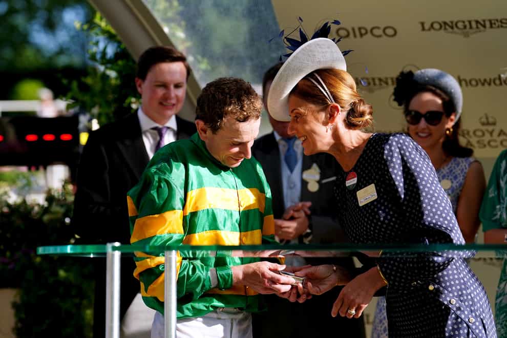 Catherine Dettori presents Ryan Moore with his award after winning the Queen Alexandra Stakes (David Davies/PA)