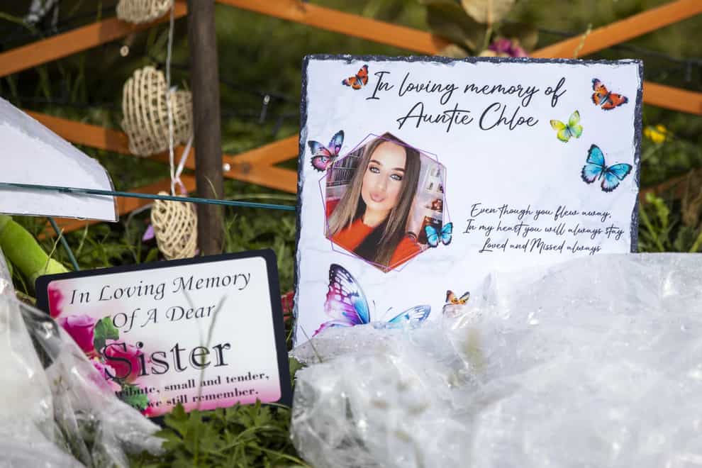 A picture of Chloe Mitchell sits with floral tributes at King George’s Park in Harryville, Ballymena (Liam McBurney/PA)