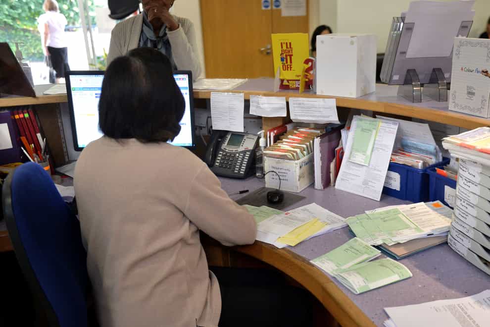 A receptionist sorts prescriptions at the Temple Fortune Health Centre GP Practice near Golders Green, London.