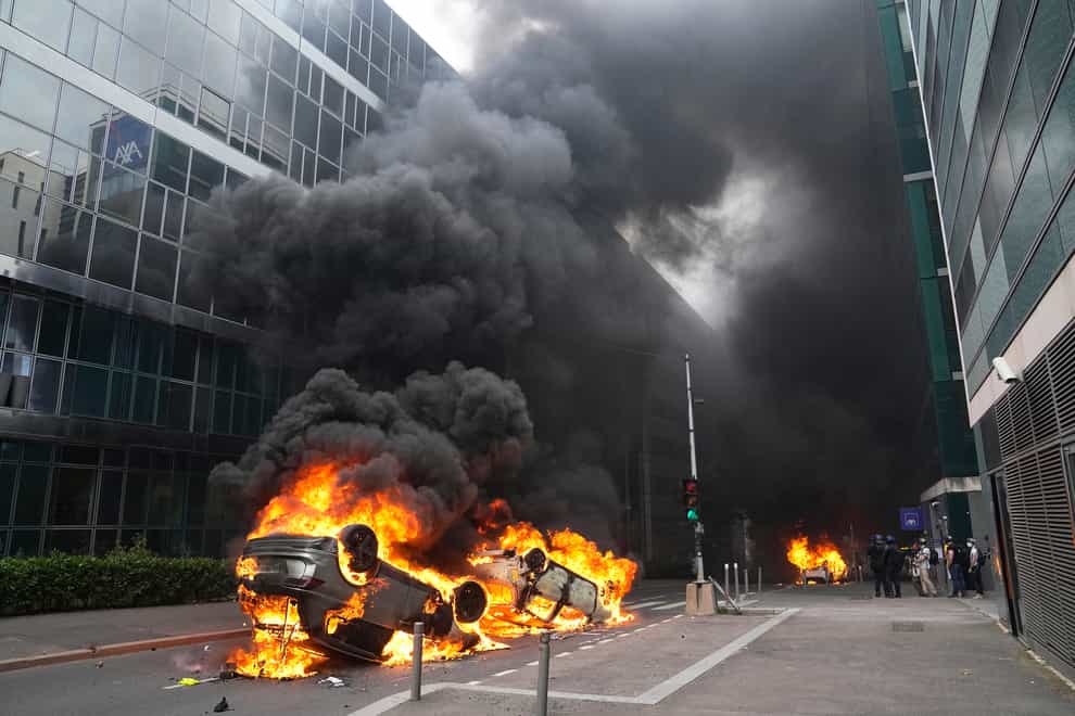 Cars burn after a march for Nahel in Nanterre (Michel Euler/AP)