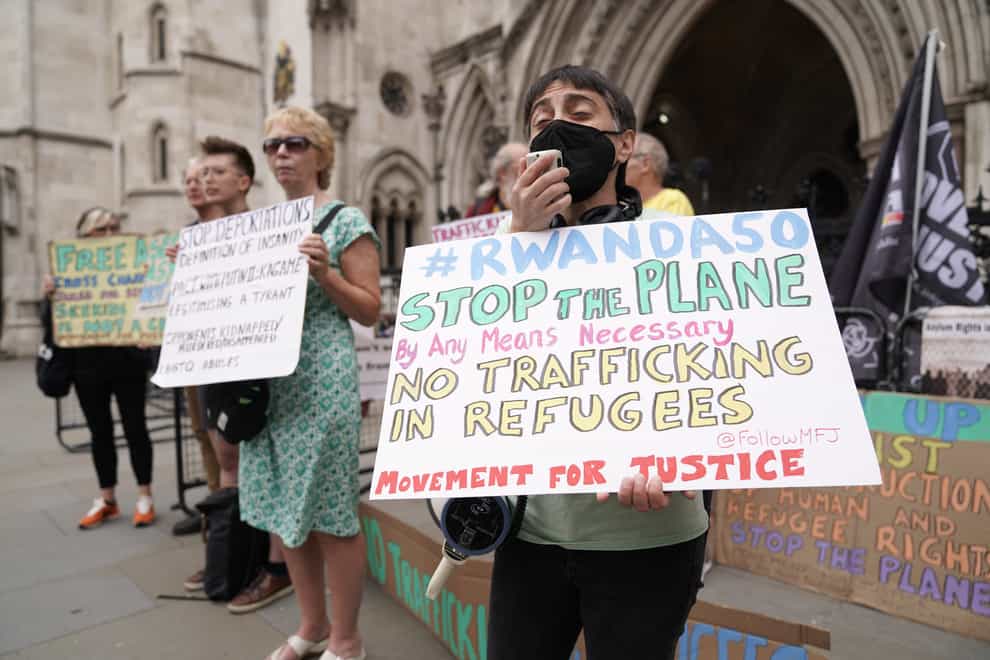 Protesters gathered outside the Royal Courts of Justice in London for the High Court’s ruling on Rwanda deportation flights (PA)