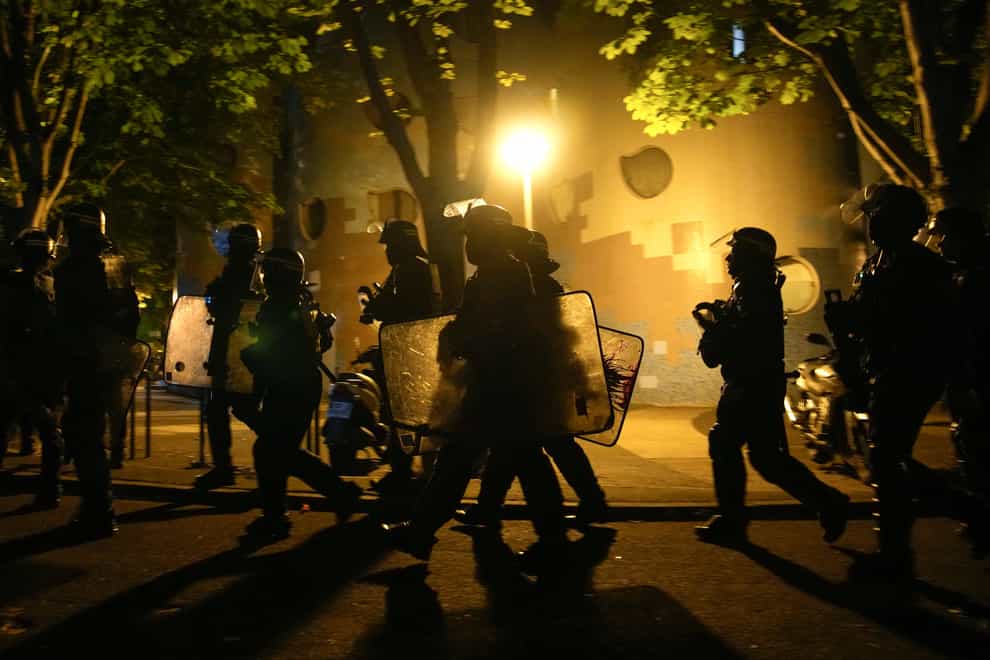 A group of police officers walk during a protest in Nanterre (Lewis Joly/AP)