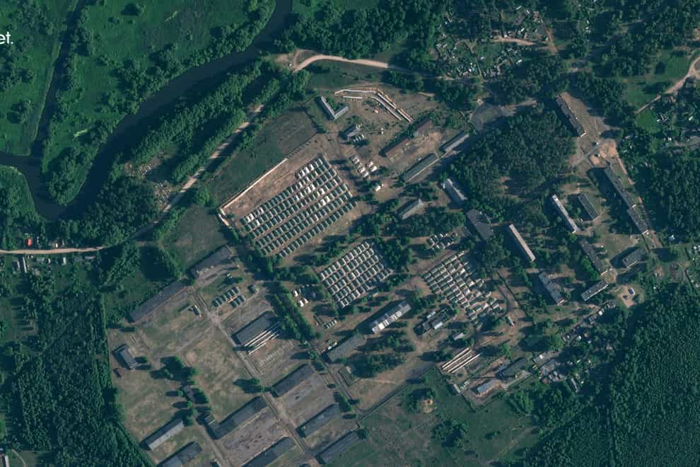 This satellite image shows apparent recent construction of tents at a former military base outside the Belarusian town of Osipovichi (Planet Labs PBC via AP)