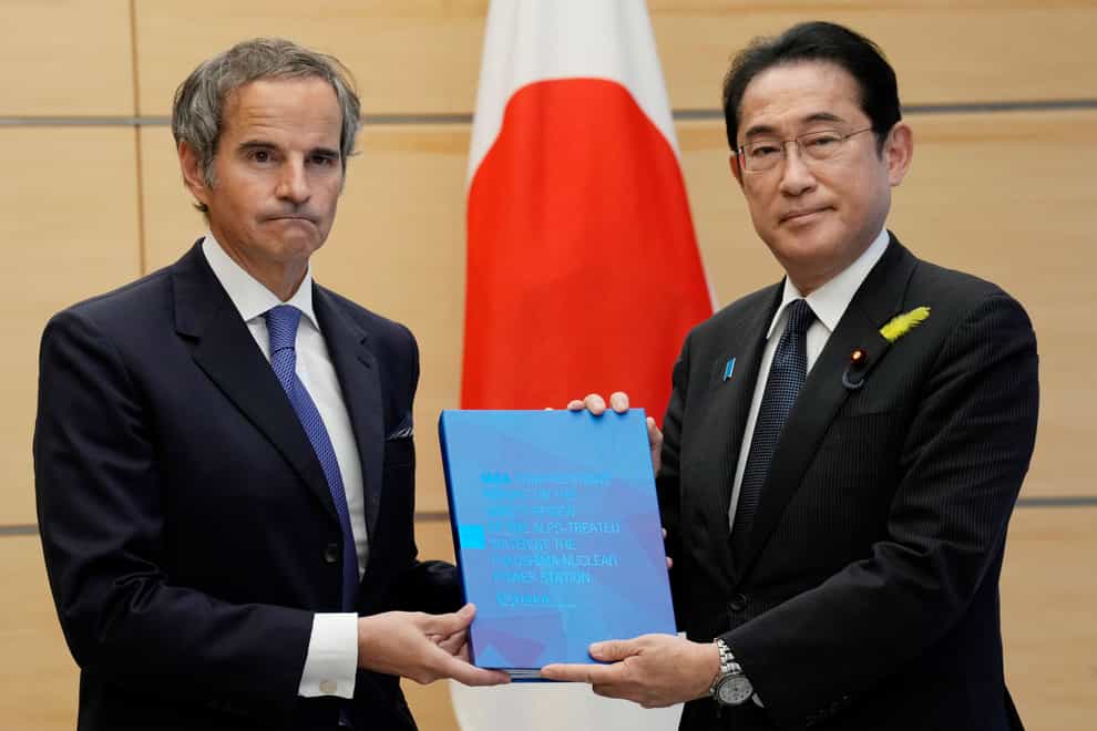 Rafael Mariano Grossi, director general of the International Atomic Energy Agency, left, presents a comprehensive report on Fukushima’s treated water release to Japanese Prime Minister Fumio Kishida (Eugene Hoshiko/AP)