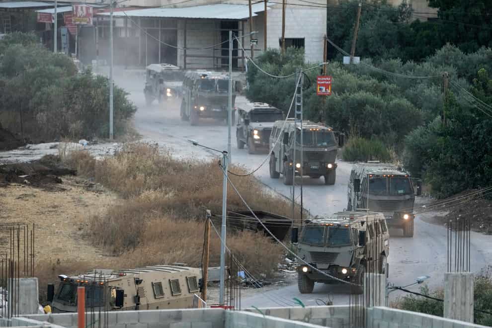 A convoy of army vehicles is seen during a military raid in the Jenin refugee camp, a militant stronghold, in the occupied West Bank (Majdi Mohammed/AP/PA)