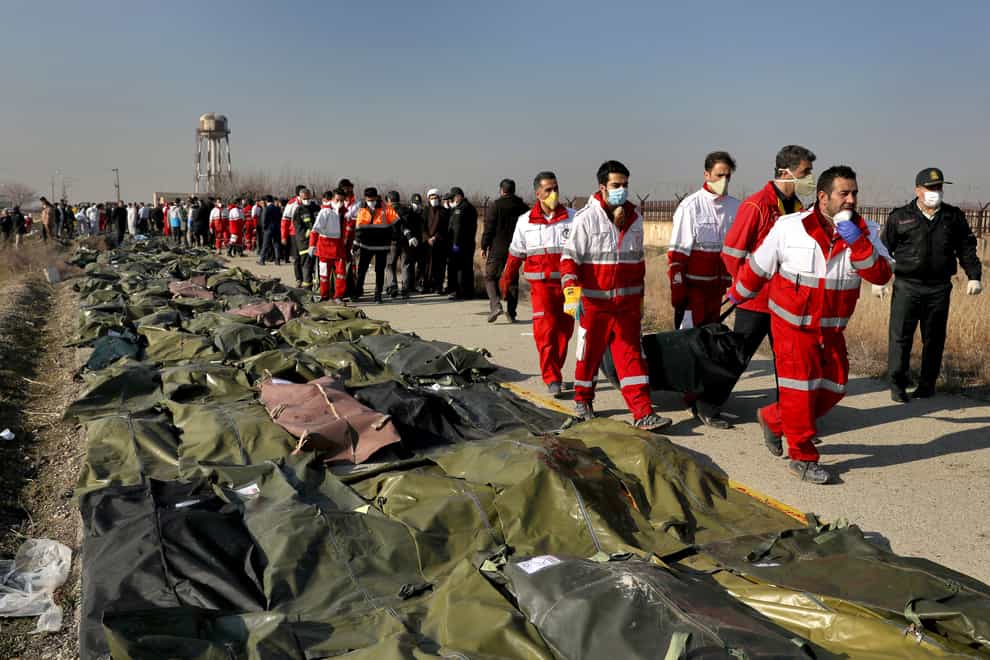 Rescue workers at the scene of the 2020 Ukrainian plane crash in Shahedshahr, Iran. The UK, Canada, Sweden and Ukraine have launched a case against Iran at the UN’s highest court (Ebrahim Noroozi/AP/PA)