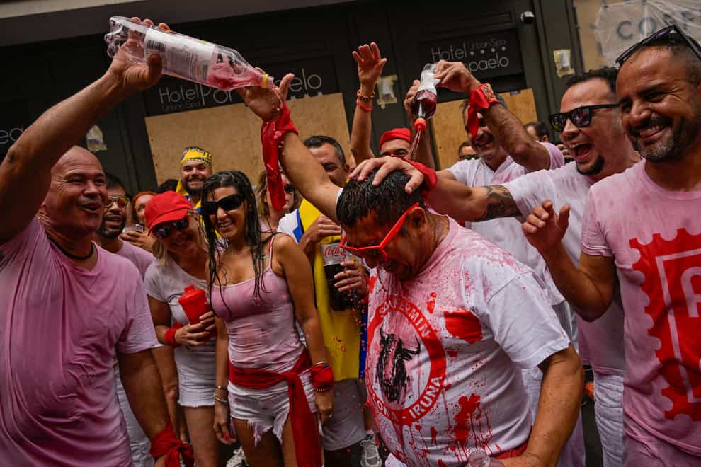 Many revellers doused each other with red or sparkling wine (Alvaro Barrientos/AP)