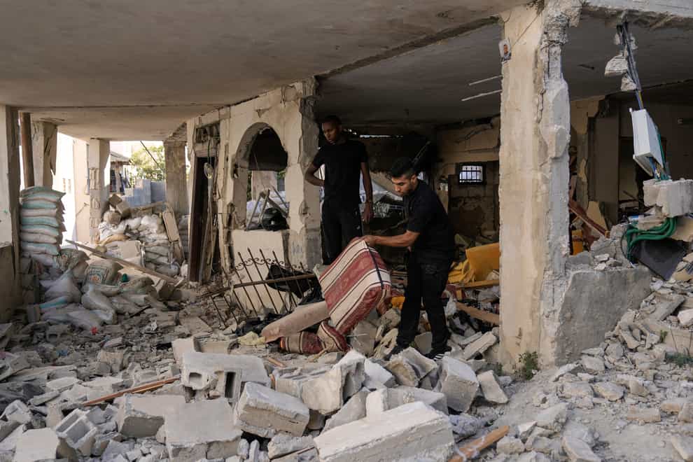 Palestinians inspect a damaged house in the Jenin refugee camp in the West Bank on Wednesday (Majdi Mohammed/AP)