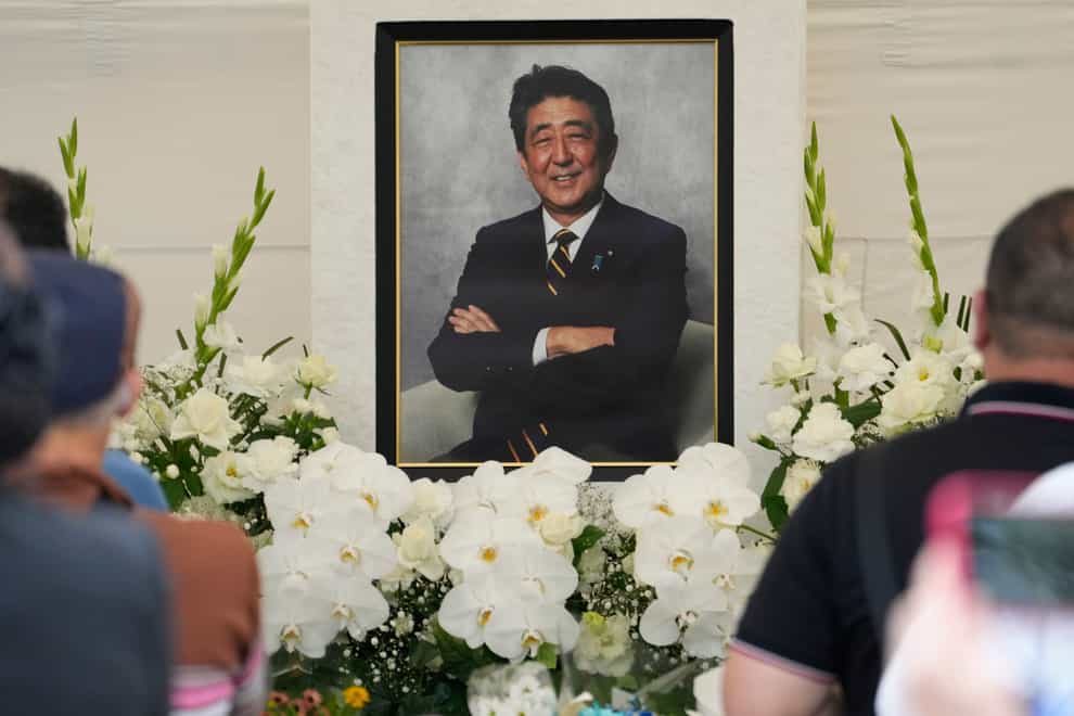 People offer prayers for Shinzo Abe at Zojoji temple in Tokyo (Shuji Kajiyama/AP)