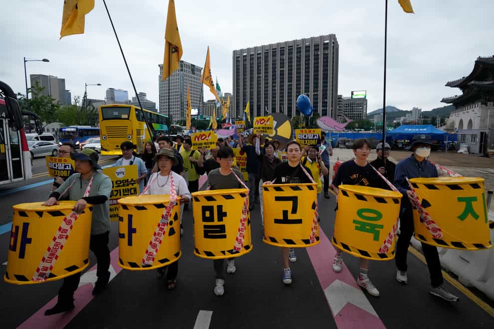 Protesters march toward the Japanese embassy in Seoul during a rally against the Japanese government’s decision to release treated radioactive water from the damaged Fukushima nuclear power plant (Ahn Young-joon/AP)