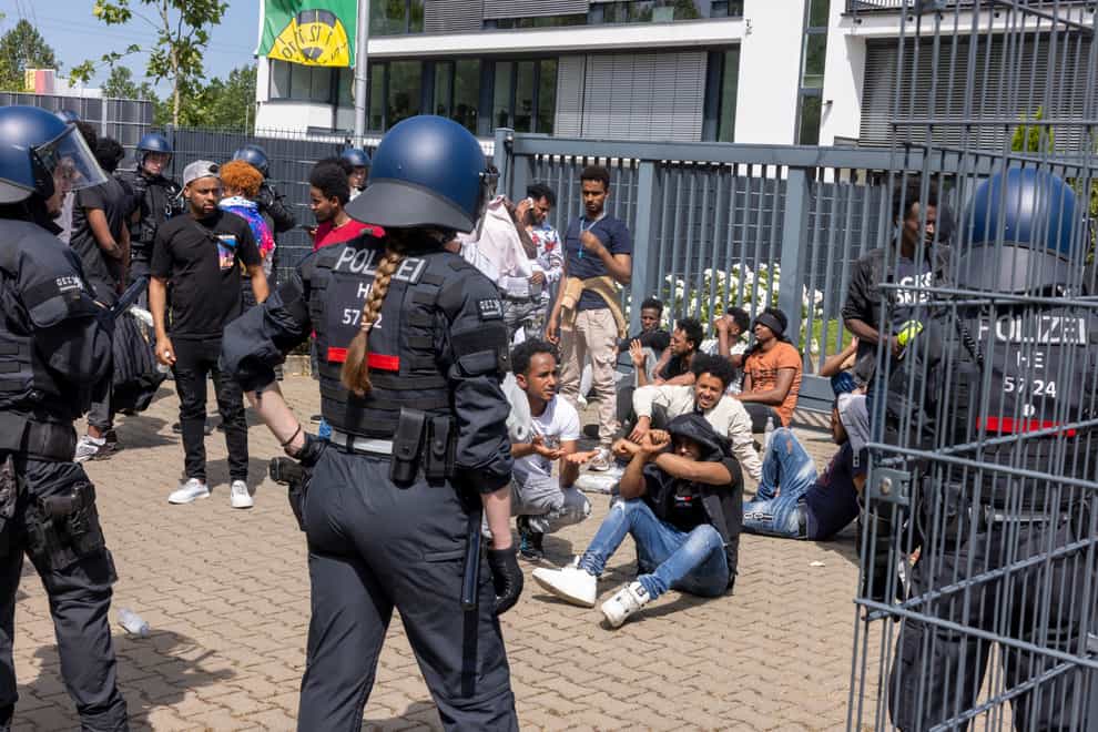 Police officers surrounded a group of people before the start of the Eritrea Festival in Giessen (dpa via AP)