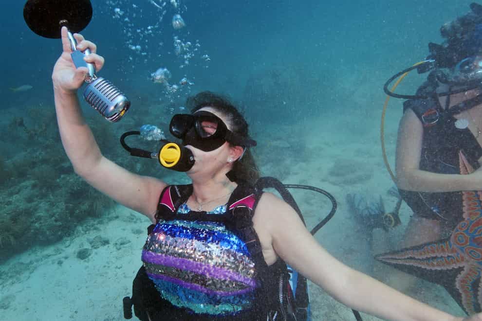 Kristen Livengood pretends to sing underwater during the event at the Lower Keys Underwater Music Festival(Frazier Nivens/Florida Keys News Bureau via AP)