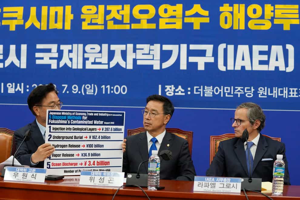 Main opposition Democratic Party politician Woo Won-shik, left, shows a list of proposed disposal methods for the Fukushima contaminated water as his colleague Wi Seong-gon and Rafael Mariano Grossi, Director General of the International Atomic Energy Agency, right, look on during a meeting with the party at the National Assembly in Seoul, South Korea (Ahn Young-joon/AP/PA)