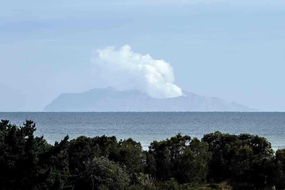 Plumes of steam rise above White Island off the coast of Whakatane, New Zealand after the eruption (Mark Baker/PA)