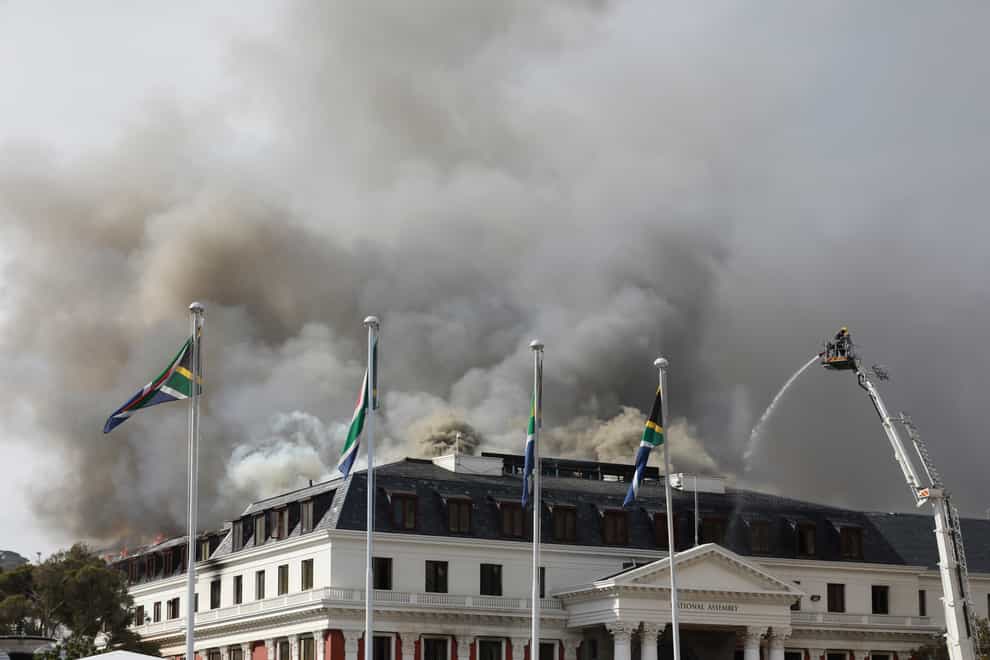 Smoke rises from the parliament in Cape Town, South Africa, in January 2022 (Nardus Engelbrecht/AP)