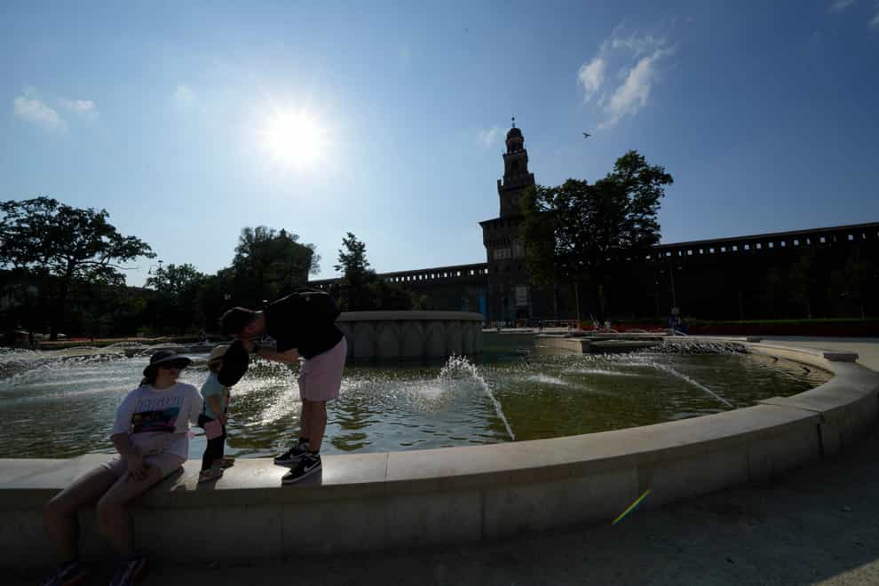 Tourists cool off in a public fountain at the Sforzesco Castle in Milan (Luca Bruno/AP)