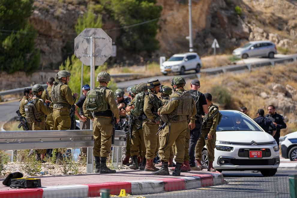Israeli authorities said a Palestinian gunman opened fire on a car in the occupied West Bank, wounding three people, including two girls, and sparking a manhunt (Ohad Zwigenberg/AP)