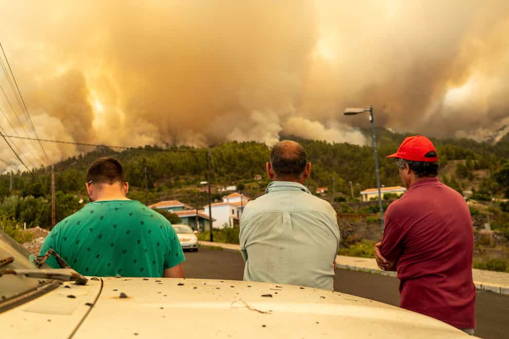 Local residents look on at a burning forest fire, near Puntagorda on the Canary Island of La Palma (Europa Press via AP)