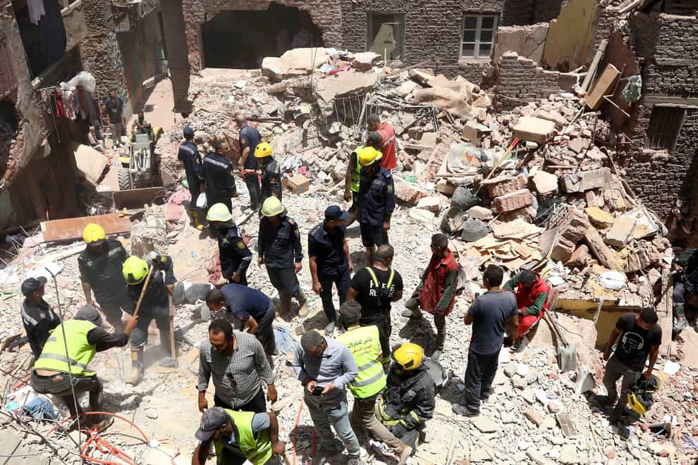Rescuers search through the rubble (AP)