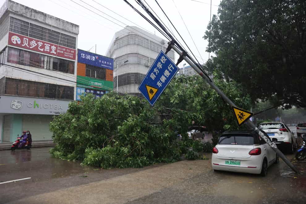 A fallen tree blocks a road amid the passage of Typhoon Talim in Qinzhou in southern China’s Guangxi Zhuang Autonomous Region (Hu Xingyu/Xinhua/AP)