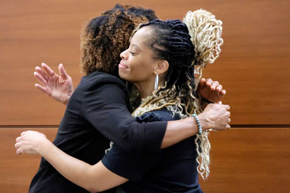 Philana Holmes, right, hugs her attorney, Keyla Smith, after a jury awarded her 800,000 dollars on behalf of her daughter Olivia Caraballo, now eight, who was burned by a McDonald’s Chicken McNugget (Amy Beth Bennett/South Florida Sun-Sentinel via AP/PA)