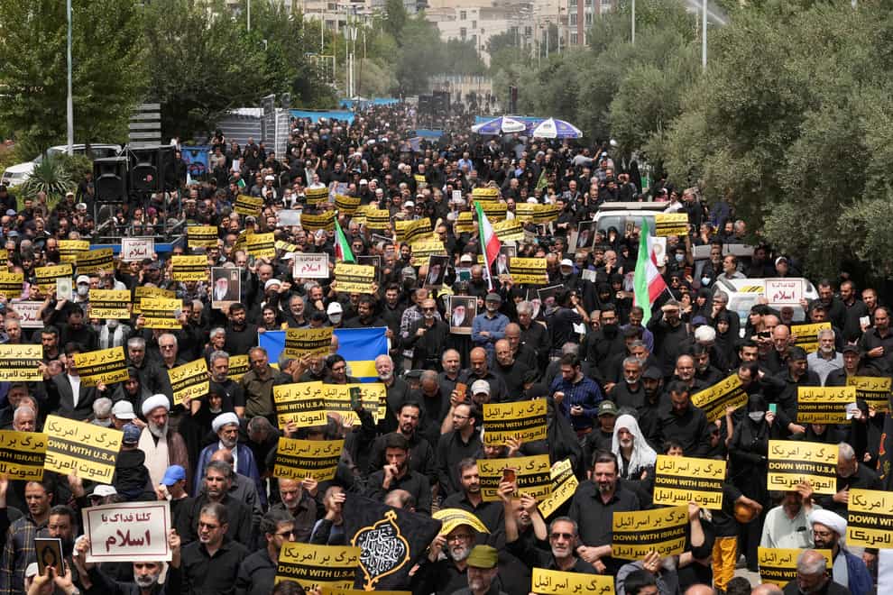 Worshippers carrying anti-US and Israel placards irotest against Sweden in Tehran (AP)