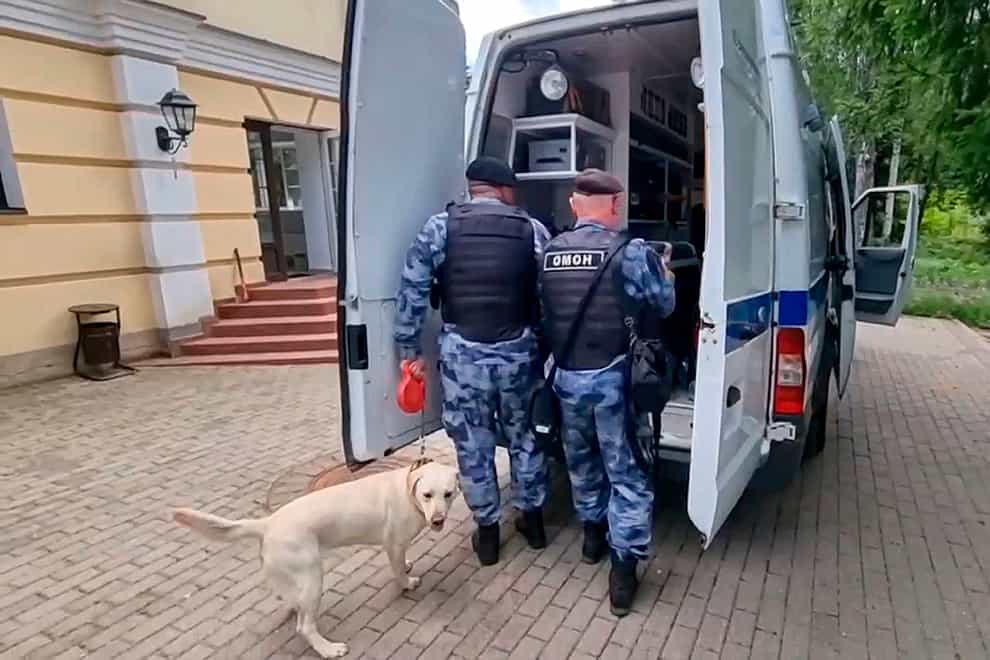 Russian national guard servicemen at the house where special forces killed the gunman (National Guard Troops Federal Service of the Russian Federation/AP)