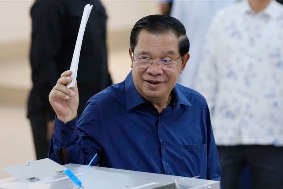 Cambodian prime minister Hun Sen of the Cambodian People’s Party (CPP) raises a ballot (Heng Sinith/AP)