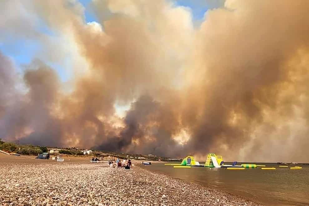Clouds of smoke from a forest fire rise to the sky on the island of Rhodes (Rhodes.Rodos via AP)