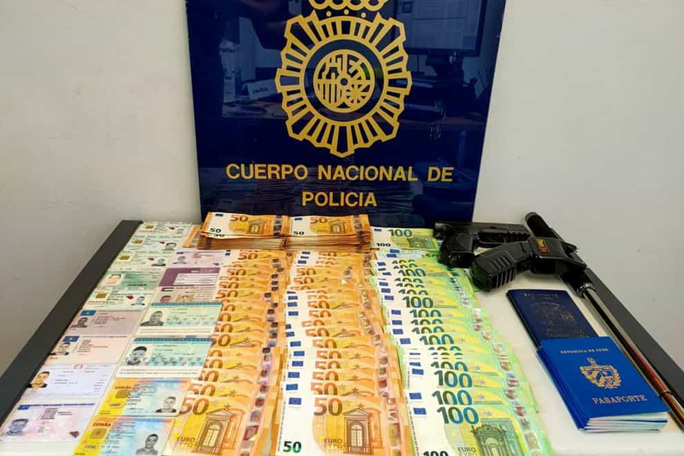 Money, weapons and documents seized in a raid (Serbian Ministry of Interior/AP)